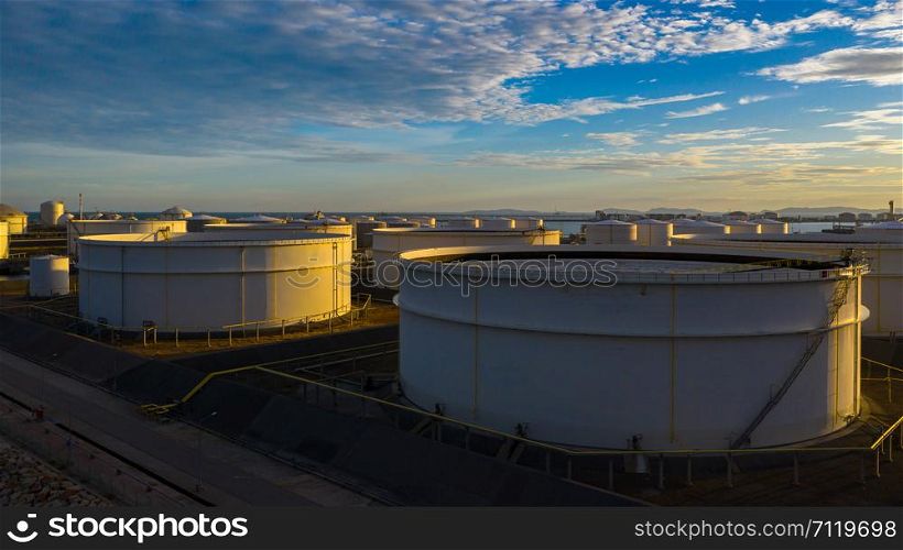 Aerial view of tank terminal with lots of oil storage tank and petrochemical storage tank at sunset, Industrial tank storage aerial view.