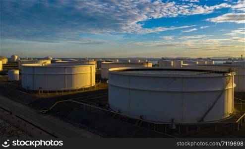 Aerial view of tank terminal with lots of oil storage tank and petrochemical storage tank at sunset, Industrial tank storage aerial view.