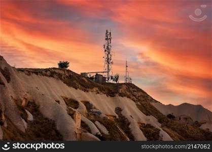 Aerial view of Telecommunication mast TV antennas at sunset on mountain