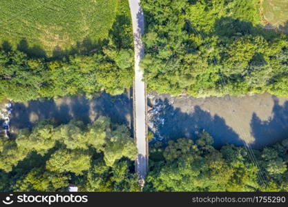 Aerial view of the bridge through the river. Top-down