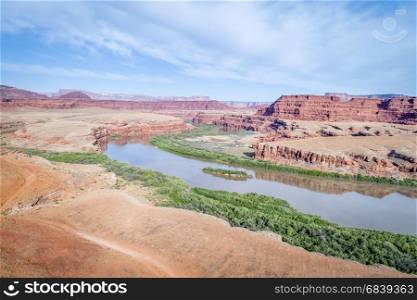aerial view of the canyon of Colorado River near Moab, Utah, with a jeep trail and camp