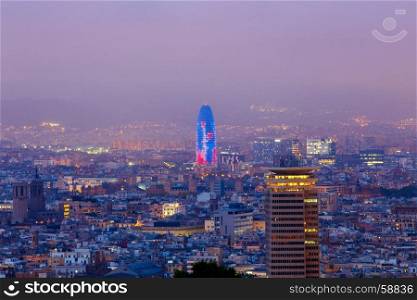 Aerial view of the city from the hill of Montjuic at sunset. Barcelona. Spain.. Barcelona. Aerial view of the city in the evening.