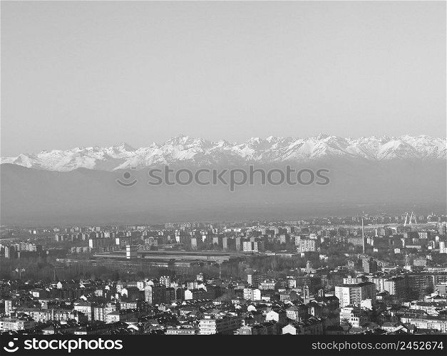 Aerial view of the city of Turin, Italy with Alps mountain range in the background in black and white. Aerial view of Turin with Alps mountains in black and white