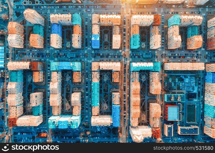 Aerial view of the colorful buildings in european city at sunset. Cityscape with multicolored houses, cars on the street in Kiev, Ukraine. Top view. Urban landscape. Aerial photo of architecture