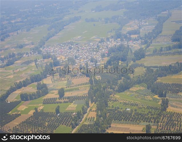 Aerial view of the countryside with village and fields of crops in summer