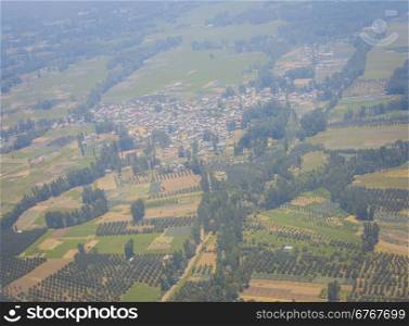 Aerial view of the countryside with village and fields of crops in summer