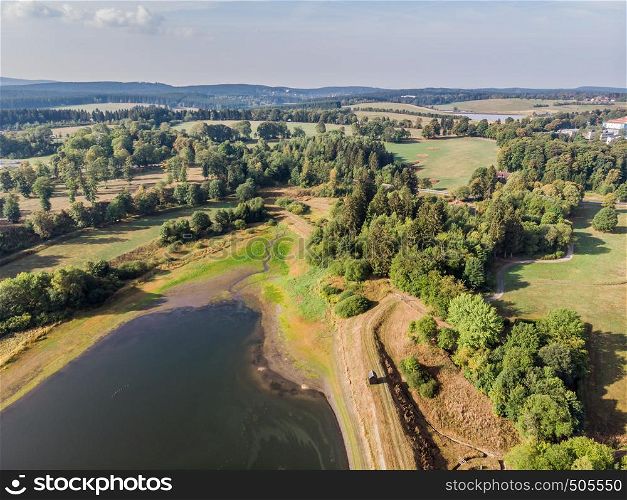 Aerial view of the dam between two artificial ponds in the Harz Mountains with drain basin and guard's cottage
