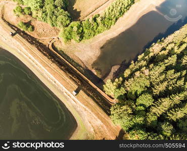 Aerial view of the dam between two artificial ponds in the Harz Mountains with drain basin and guard's cottage.