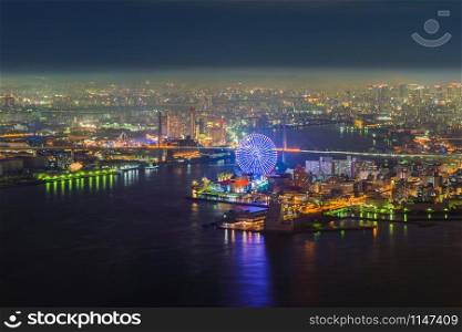 Aerial view of the ferris wheel, Tempozan The Riverfront, near Osaka Bay with skyscraper buildings in Osaka Kansai Downtown skyline, urban city, Japan. Architecture landscape background.