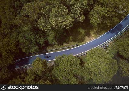 Aerial view of the forest on country road motorcycle rider , Malaysia .