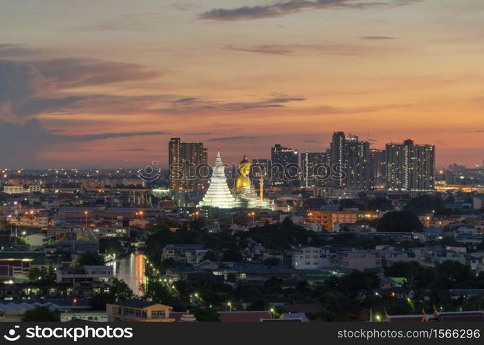 Aerial view of the Giant Golden Buddha in Wat Paknam Phasi Charoen Temple in Phasi Charoen district on Chao Phraya River at night, Bangkok. Urban town, Thailand. Downtown City.