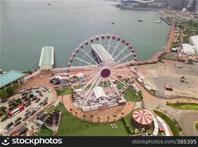 Aerial view of the Hong Kong Observation Wheel and amusement park for kids in holiday and travel concept. Hong Kong City. Downtown and Victoria Harbour.