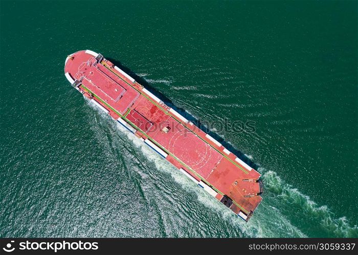 Aerial view of the huge ro-ro ship loading new cars. Automotive container carriers sailing on the sea services. Transportation business for prefabricated cars by sea freight