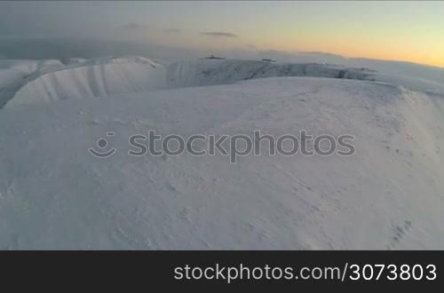 Aerial view of the mountains under the snow in winter morning
