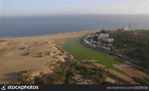 Aerial view of the ocean coast with hotels and resort areas, beach and sand dunes. Gran Canaria, Canary Islands