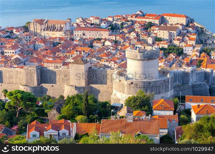 Aerial view of the old medieval historical part of the city on a sunny morning. Mincheta Tower. Dubrovnik. Croatia.. Scenic aerial view of Dubrovnik city on a sunny morning.