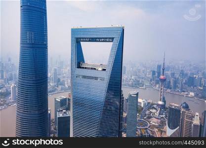 Aerial view of The Pearl at Shanghai Downtown skyline by Huangpu River, China. Financial district and business centers in smart city in Asia. Skyscraper and high-rise buildings near The Bund at noon.