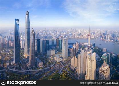 Aerial view of The Pearl at Shanghai Downtown skyline by Huangpu River, China. Financial district and business centers in smart city in Asia. Skyscraper and high-rise buildings near The Bund at noon.
