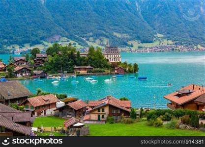 Aerial view of the peninsula and former castle and Lake Brienz in swiss village Iseltwald, Switzerland. Swiss village Iseltwald, Switzerland