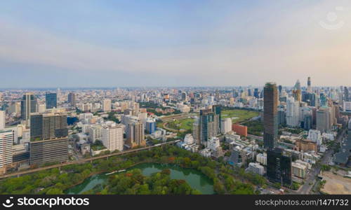 Aerial view of The Royal Bangkok Sports Club in Ratchadamri district, Bangkok Downtown Skyline. Thailand. Financial district in smart urban city in Asia. Skyscraper and high-rise buildings at sunset.