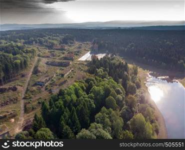 Aerial view of the ruins of an old industrial plant in the Harz Mountains next to an artificial pond.