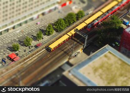 Aerial view of the S-Bahn tracks rapid train and tram train at the Alexanderplatz public square in Berlin. with tilt-shift effect.