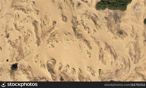 Aerial View of the Textures and Patterns of the Desert Sands. Beautiful landscape . Desert and green bushes.. Aerial View of the Textures and Patterns of the Desert Sands. Beautiful landscape . Desert and green bushes