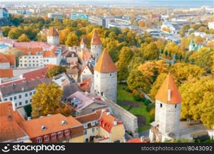 Aerial view of the tiled roofs, spiers and streets in the historical part of old Tallinn.
