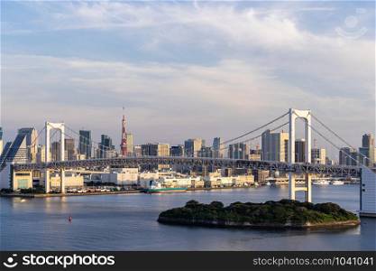 Aerial view of Tokyo skylines with Rainbow bridge and tokyo tower over Tokyo bay in daytime from Odaiba in Tokyo city Kanto Japan.