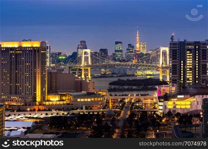 Aerial view of Tokyo Sunset with Tokyo tower and Rainbow bridge with Tokyo cityscape in background from Odaiba Japan.