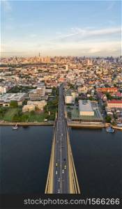Aerial view of top of Rama 8 Bridge and Chao Phraya River in structure of suspension architecture concept, Urban city, Bangkok skyline. Downtown area, Thailand.