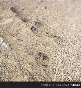 Aerial view of torrid California desert with rocky landforms.