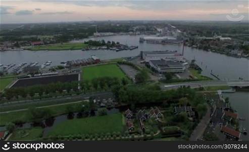 Aerial view of town with green areas, river and boats at anchor. Netherlands