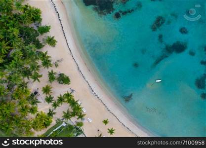 Aerial view of tropical beach with white boat anchored.Samana peninsula,Bahia Principe beach,Dominican Republic.