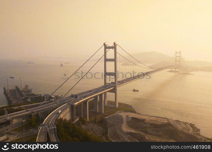 Aerial view of Tsing Ma Bridge. Highways in Hong kong with structure of suspension architecture in transportation and travel concept. Urban city at sunset.