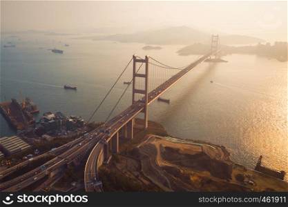 Aerial view of Tsing Ma Bridge. Highways in Hong kong with structure of suspension architecture in transportation and travel concept. Urban city at sunset.