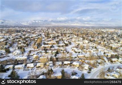 aerial view of typical residential neighborhood along Front Range of Rocky Mountains in Colorado, winter scenery with fresh snow