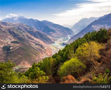 Aerial view of village and river at the valley of high mountain in Sichuan, China
