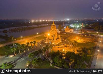 Aerial view of Wat Panyanantaram at night, a Buddhist temple in Pathum Thani City, Thailand. Thai architecture buildings background in travel trip concept. Buddhism religion. Tourist attraction.