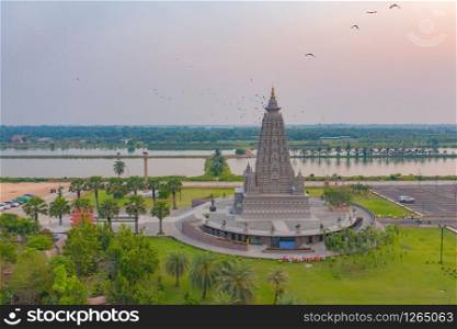 Aerial view of Wat Panyanantaram at sunset, a Buddhist temple in Pathum Thani City, Thailand. Thai architecture buildings background in travel trip concept. Buddhism religion. Tourist attraction.