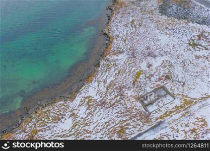 Aerial view of white snow mountain in Lofoten islands, Nordland county, Norway, Europe. Hills and trees, nature landscape in winter season. Top view. Pattern texture background.