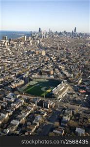 Aerial view of Wrigley Field with Chicago, Illinois skyline in background.