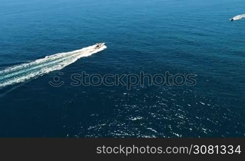 Aerial view of yachts swimming past each other in the open sea at high speed. Spain, Catalonia