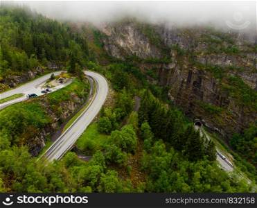 Aerial view. Old and new road with tunnel in green summer mountains, Mabodalen valley Norway. National tourist Hardangervidda route.. Aerial view. Road with tunnel in mountains Norway