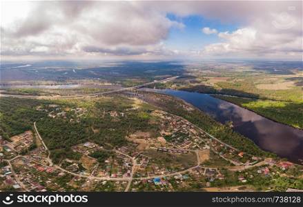 Aerial view on flowing river and town. Aerial view on river and town