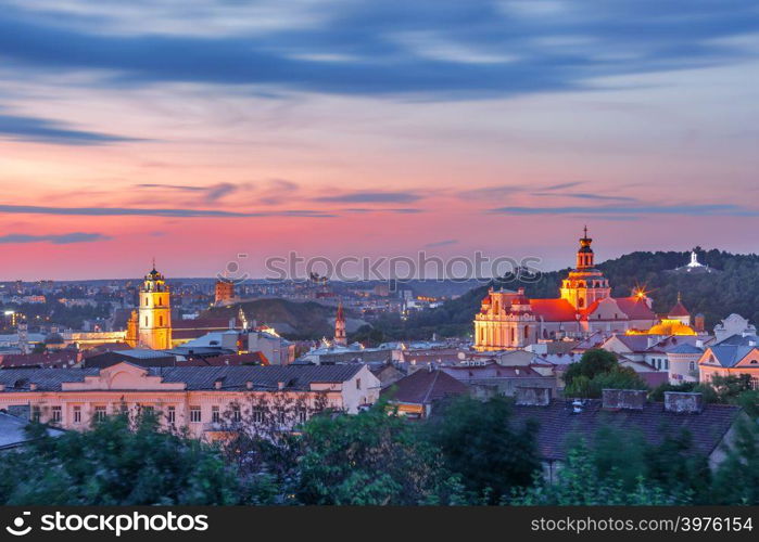 Aerial view over Old town with Gediminas Castle Tower, churches and Three Crosses on the Bleak Hill at sunrise, Vilnius, Lithuania, Baltic states.. Old town at sunset, Vilnius, Lithuania
