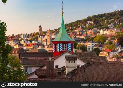 Aerial view over roofs and towers of Old Town of Zurich, the largest city in Switzerland at sunset.. Zurich, the largest city in Switzerland