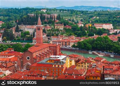 Aerial view over Santa Anastasia Church and red roofs in cloudy summer day, Verona, Italy