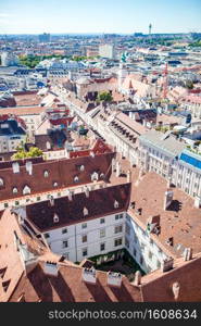 Aerial view over the rooftops of Vienna from the north tower of St. Stephen’s Cathedral. View from St. Stephen’s Cathedral over Stephansplatz square in Vienna, capital of Austria on sunny day