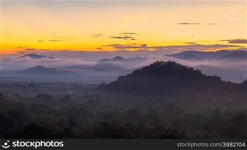 Aerial view, panoramic view of the morning scenery, consisting of mountains, clouds and fog and beautiful sun near Mae Moh Lampang Province, Thailand.. Aerial view, panoramic view of the morning scenery.